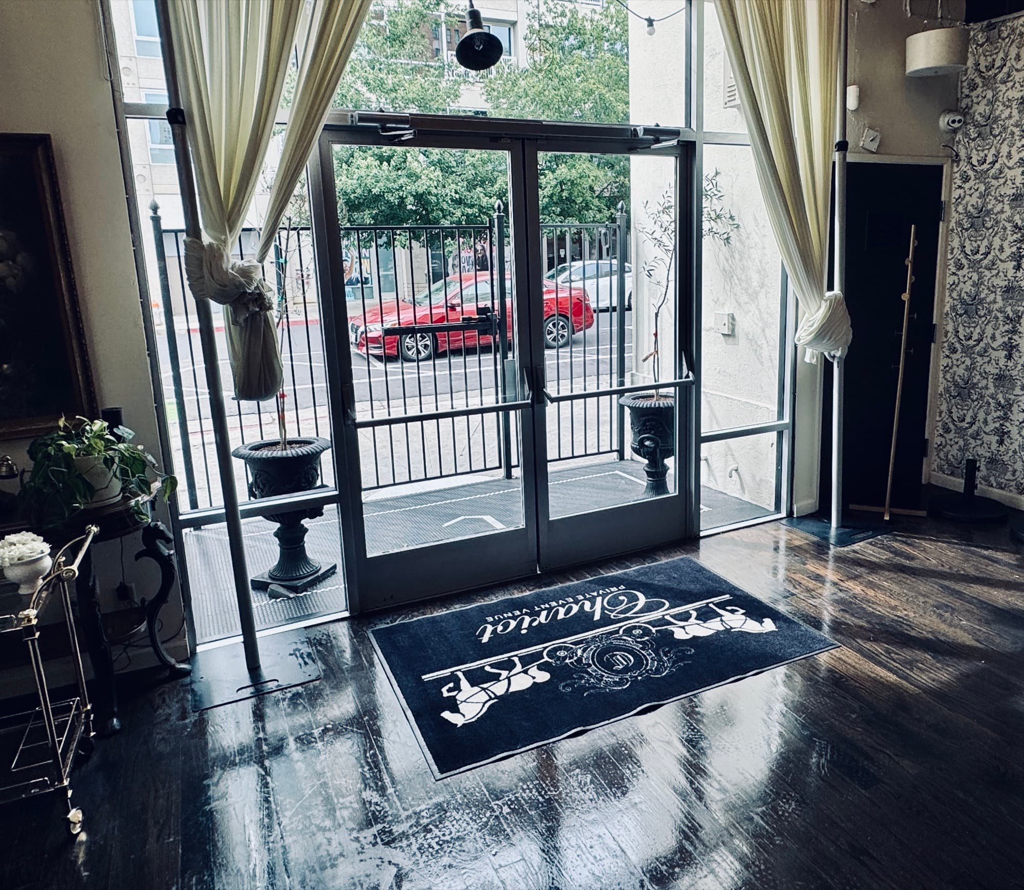 The view from inside the front door — light coming through the glass entry onto the Chariot Gathering House mat.